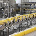 Juice bottles moving along the conveyor belt