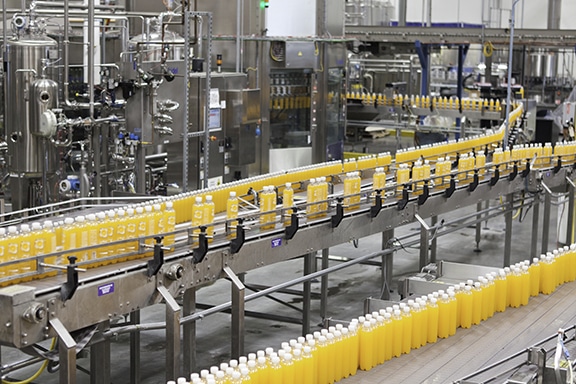 Bottling plant conveyor belt Juice bottles moving along the conveyor belt