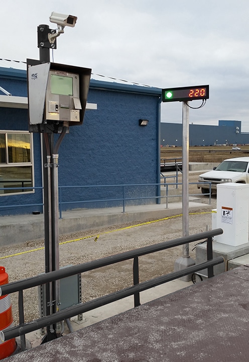 Unmanned truck scale kiosk with camera & remote scoreboard display