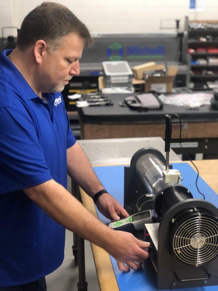 Michelli technician performs environmental calibration on an anemometer using a wind tunnel Michelli technician performs environmental calibration on an anemometer using a wind tunnel