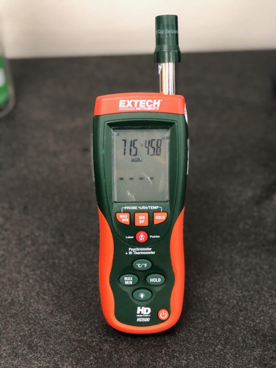 Orange Psychrometer & Infrared Thermometer used in environmental measurement