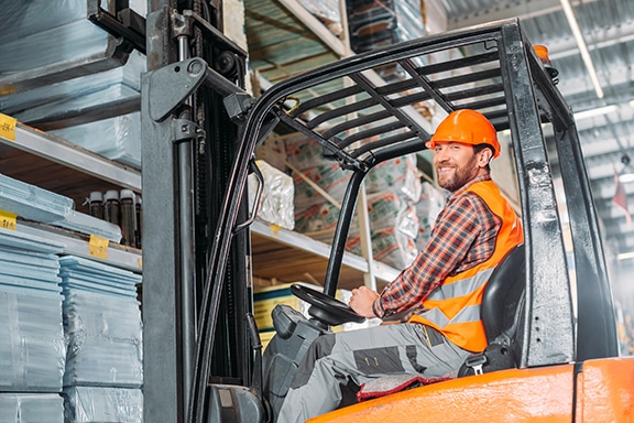 Man on forklift practicing proper safety