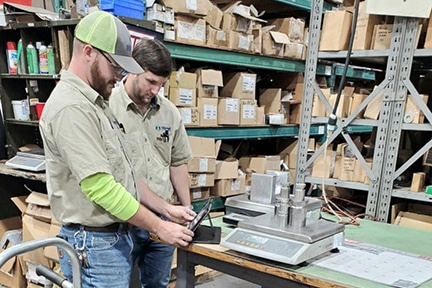 Scale calibration in progress web Michelli Weighing & Measurement technicians perform scale calibration on site