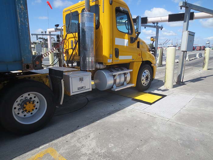 Yellow truck rolls over Intercomp weigh-in-motion truck scale