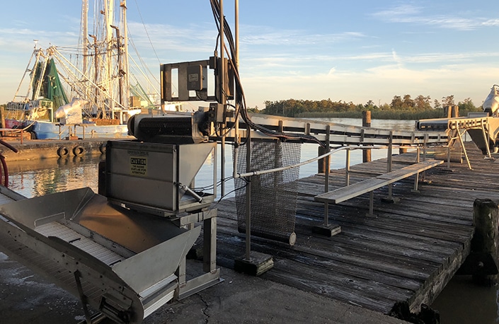 Dockmate bulk weigher system connected to a conveyor belt on a dock