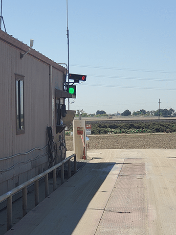 Unattended truck scale weighing system with traffic light