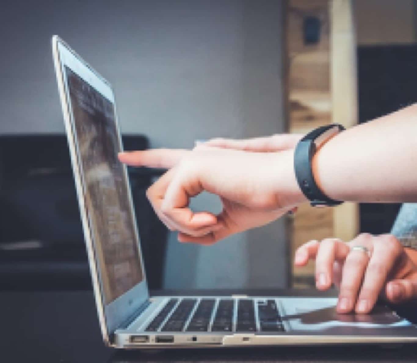 Finger pointing at laptop computer screen Finger pointing at laptop computer screen