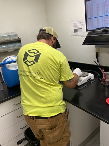 Lab Balance Calibration Michelli Weighing & Measurement service technician performs lab balance calibration with certified test weights