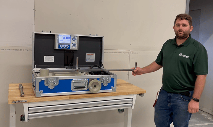 Andrew from Michelli Weighing & Measurement stands next to a portable torque calibration box that enables the Michelli team to perform on-site torque calibration