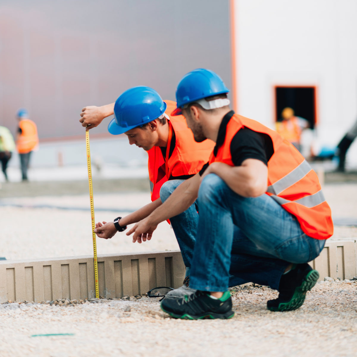 Construction workers take measurements on-site to ensure safety