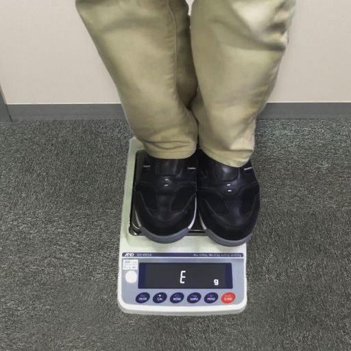 feet standing on top of a A&D Apollo IP65 Balance to illustrate robust construction