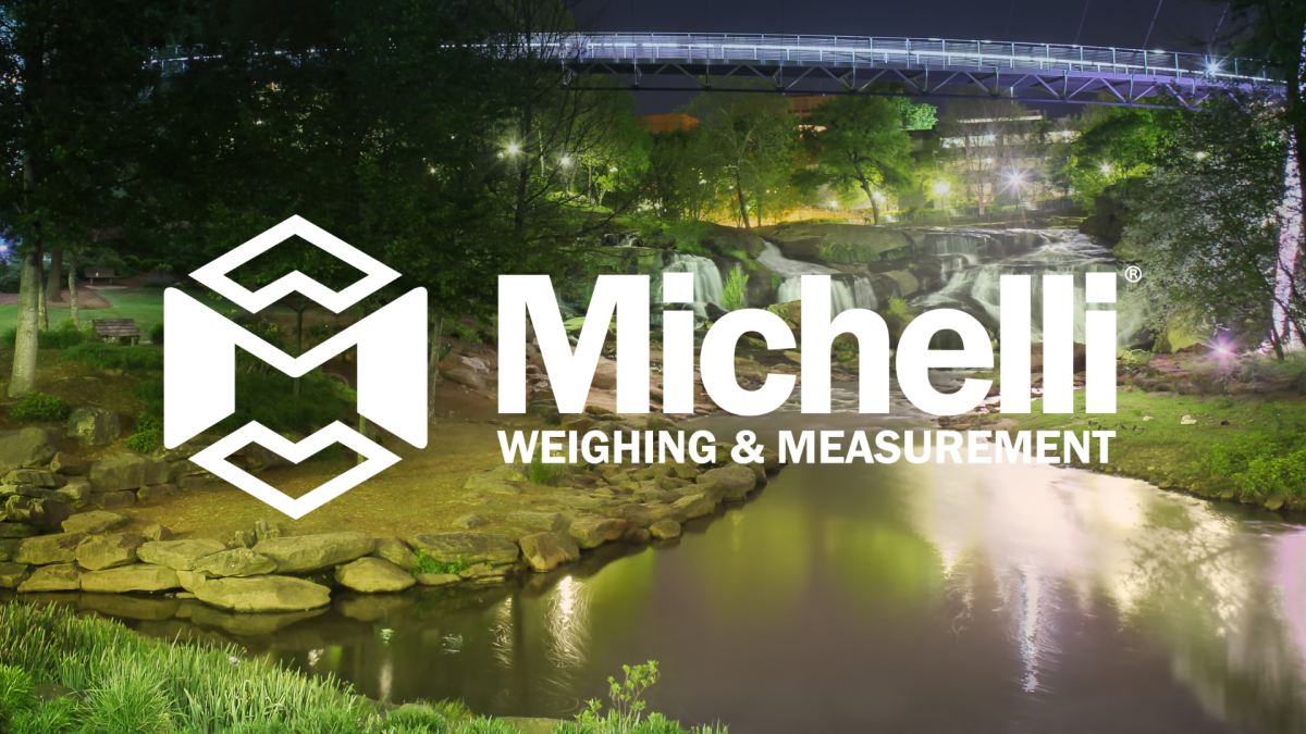 Michelli Weighing & Measurement logo over Falls Park on the Reedy in Greenville, South Carolina at night.